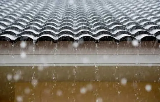 Rain running off the roof of a painted home